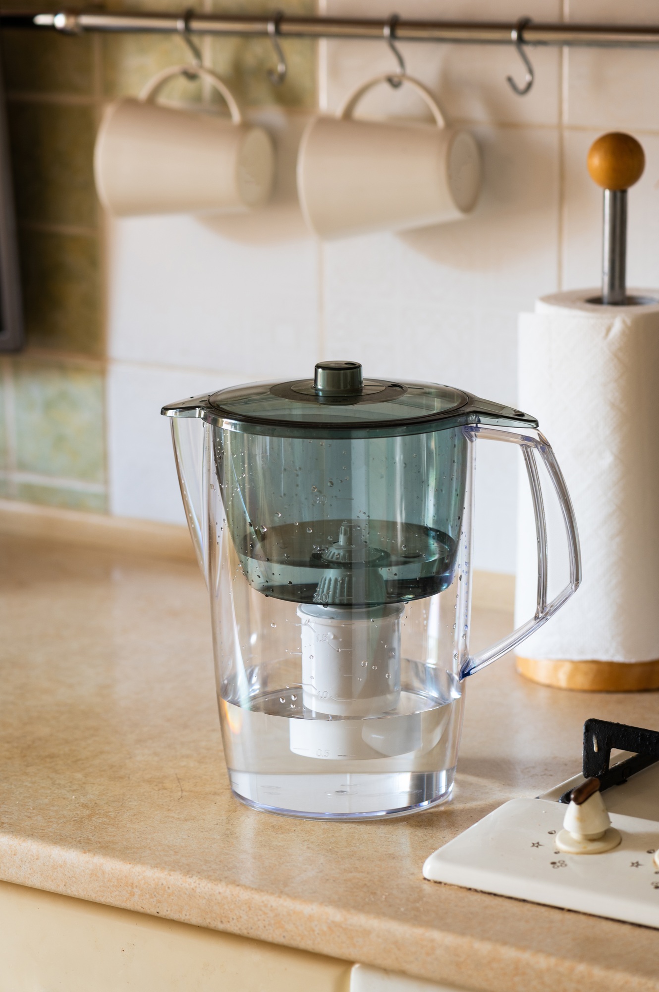 Water filter jug on kitchen table. Clean water concept. Filtration water